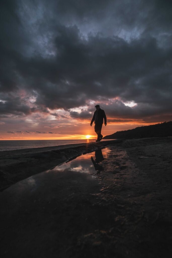 Things-to-do-in-lyme-regis: Simon Emmett photo of man on Cobb