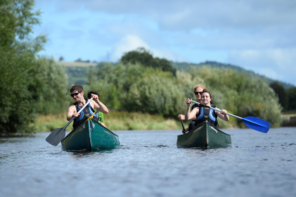 people canoeing down the river wye
