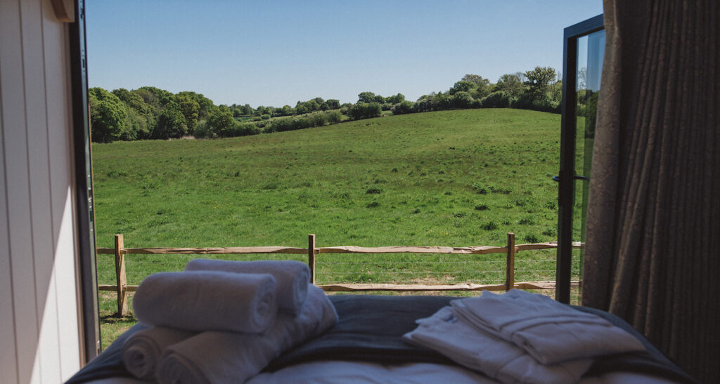 long view lodge glamping in sussex - outside view from bed
