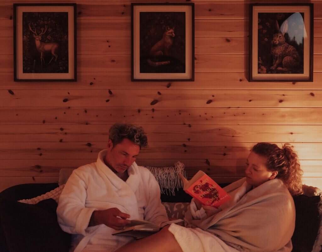 couple reading at the nook glamping cheltenham