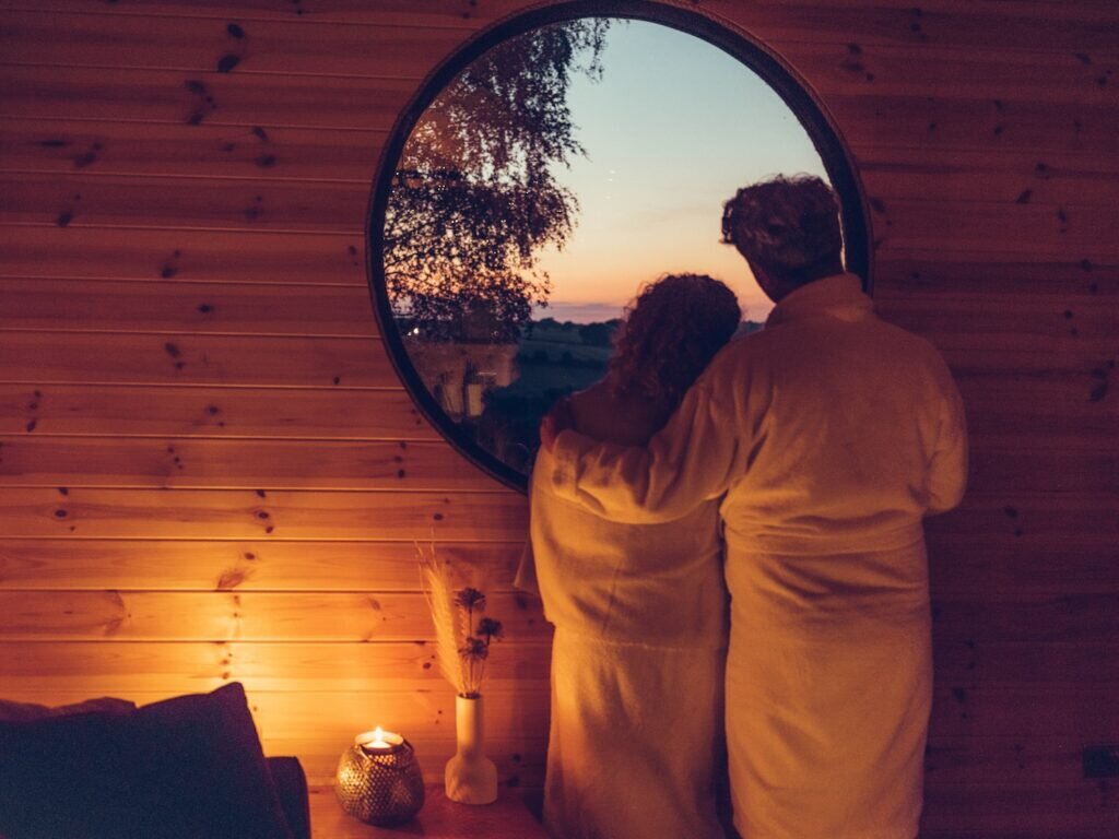 couple looking out of window in the nook glamping cheltenham